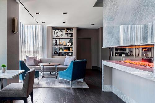 a living room with a table and chairs at Toronto Marriott Markham in Markham