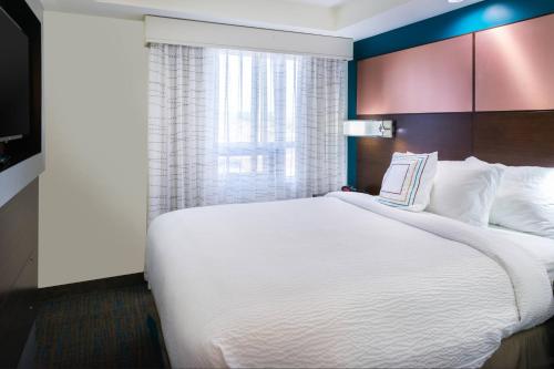 a large white bed in a room with a window at Residence Inn by Marriott Temecula Murrieta in Murrieta