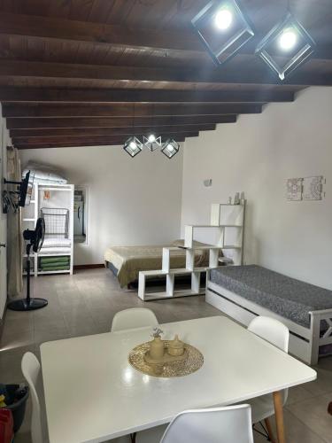 a living room with a table and a bed at Las Gardenias in Mar del Plata