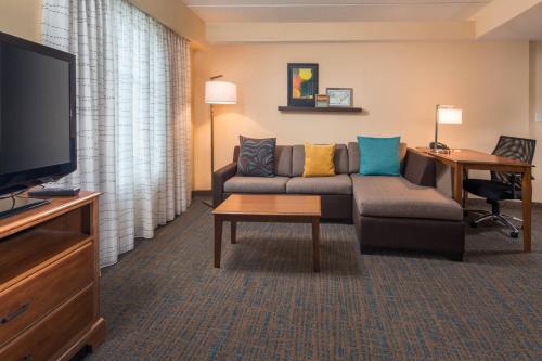a living room with a couch and a tv at Residence Inn by Marriott Chesapeake Greenbrier in Chesapeake