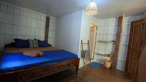 a bedroom with a blue bed in a room at Deja Vu Bungalows in Koh Rong