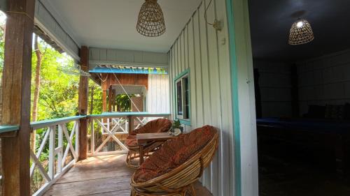 a porch with chairs and a table on a porch at Deja Vu Bungalows in Koh Rong