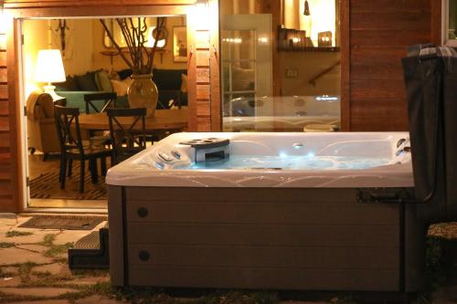 a jacuzzi tub in the middle of a living room at Lux 4br Cabin W Hot Tub & Patio in Bailey