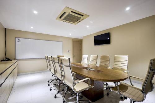 a conference room with a wooden table and chairs at Protea Hotel by Marriott Kampala Skyz in Kampala