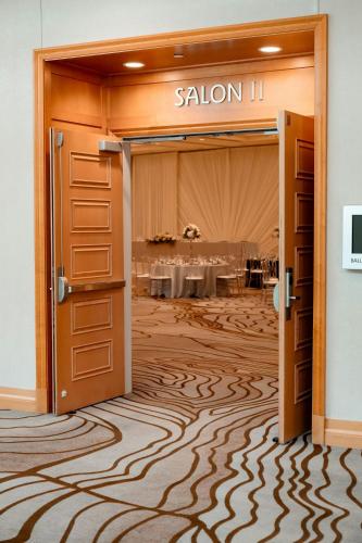 a door leading to a dining room with a table at San Jose Marriott in San Jose