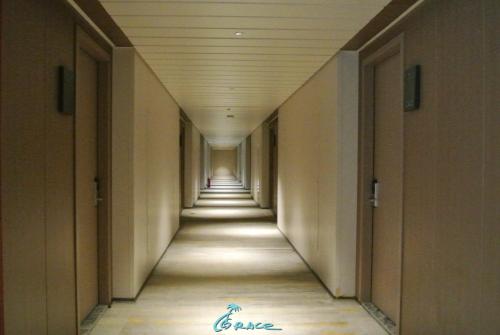 an empty hallway in a building with a long corridor at Grace Hotel in Honiara