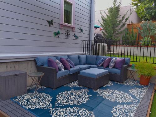 a patio with a blue couch on a house at Victorian House-30 mins to Napa & SF, Free Pets! in Crockett