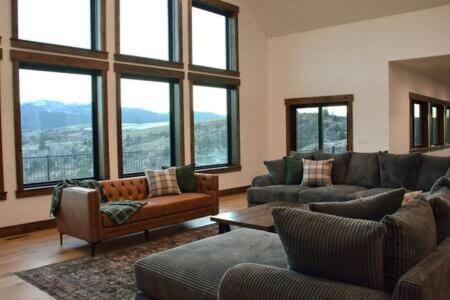 a living room with couches and windows with a view at Trails End Lodge in Irwin