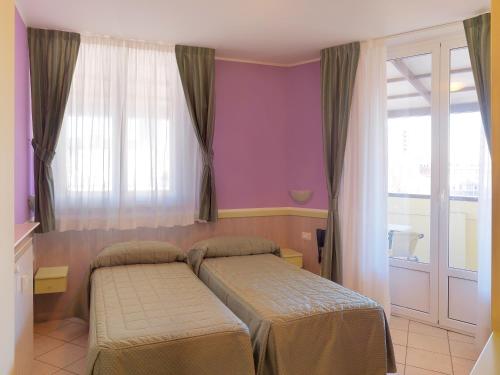 Postel nebo postele na pokoji v ubytování Hotel Arco Romana