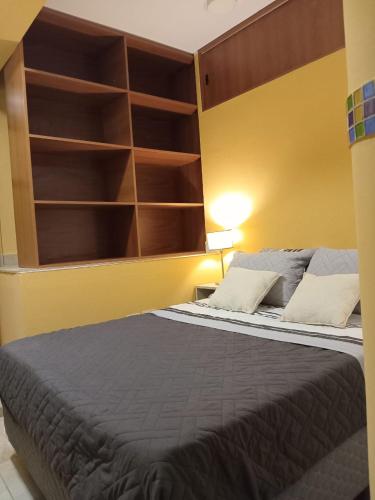 a bedroom with a large bed with a large headboard at Departamento Letty I - Con Cochera in San Salvador de Jujuy