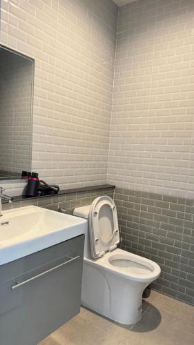 a bathroom with a white toilet and a sink at Vela House Songkhla in Songkhla
