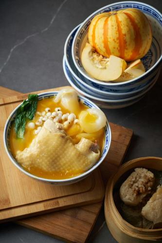 a bowl of soup with a pumpkin and a bowl of food at The Westin Bund Center, Shanghai in Shanghai