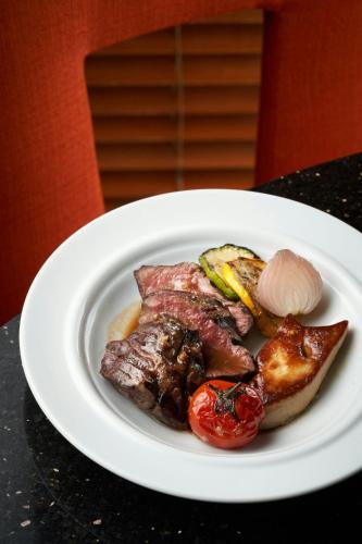a plate of food with meat and vegetables on a table at The Westin Bund Center, Shanghai in Shanghai