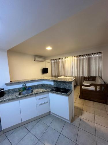 a kitchen with a sink and a counter top at Suites Centro Torres in Torres