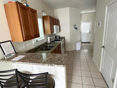 a kitchen with a sink and a counter top at Contemporary 2-BR cottage, 2 Blocks to Beach in Myrtle Beach