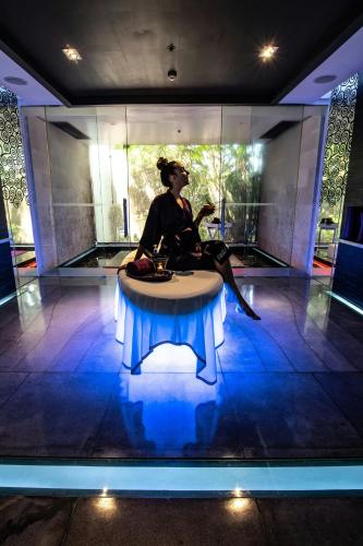 a woman sitting on a table in a room at W Bali - Seminyak in Seminyak