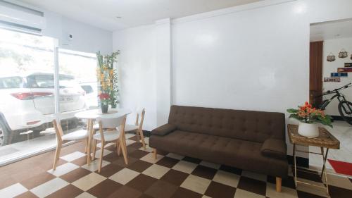 a living room with a couch and a table at RedDoorz at Socor Pension House Iligan City in Iligan City