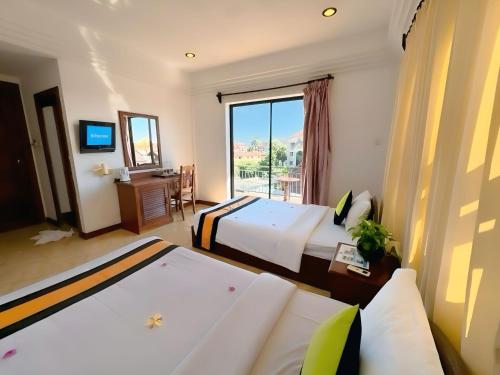 Postel nebo postele na pokoji v ubytování VPlus Hotel