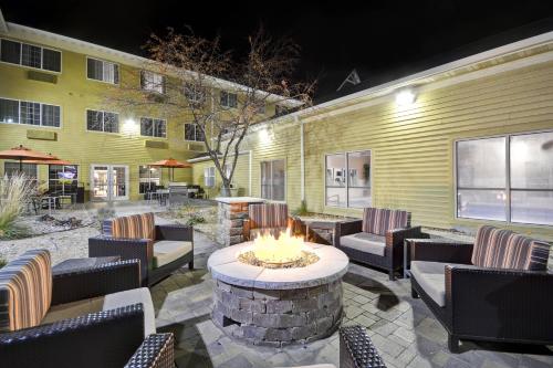 a patio with a fire pit in front of a building at TownePlace Suites Sioux Falls in Sioux Falls