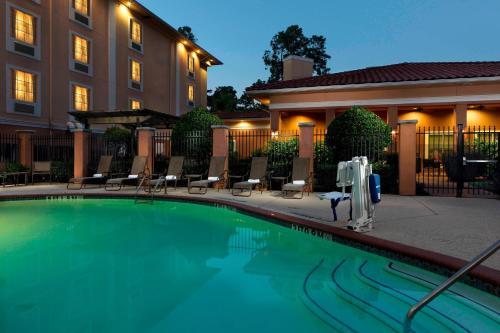 a swimming pool in front of a building at TownePlace Suites Houston Intercontinental Airport in Houston