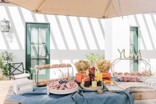 a table with a blue table cloth and food on it at Moxy Santa Barbara in Santa Barbara
