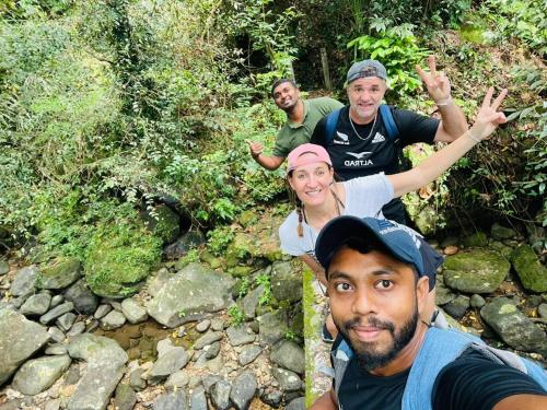 a group of people posing for a picture near a creek at Palabaddala Tea and Eco Lodge in Ratnapura