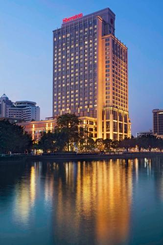 a santander hotel is lit up at night in a city at Sheraton Zhongshan Hotel in Zhongshan