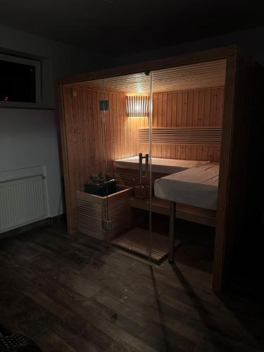 a bedroom with two beds and a wooden floor at Vila Florilor Predeal in Predeal