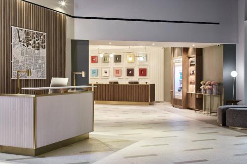 a lobby with a reception desk in a building at London Marriott Hotel Kensington in London