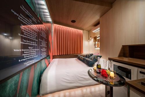 a small room with a bed and a table at Hotel CARA 大人専用Adult only hotel in Tokyo