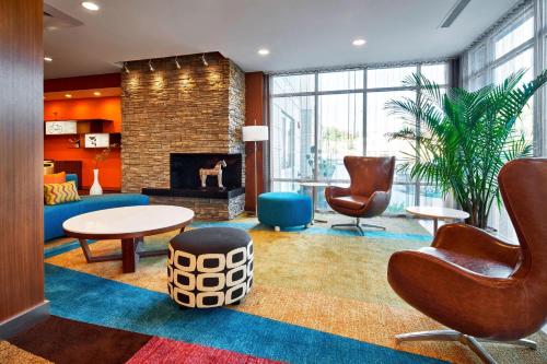 a lobby with a living room with a fireplace at Fairfield Inn & Suites by Marriott Alexandria,Virginia in Alexandria