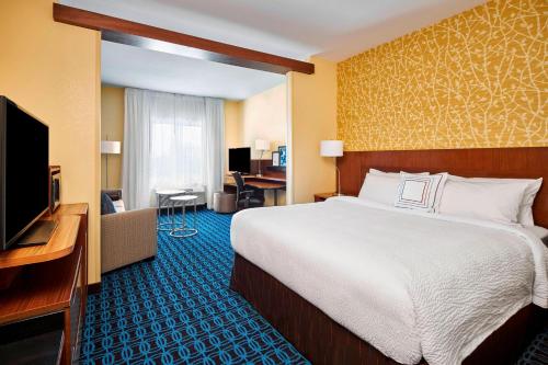 a hotel room with a bed and a flat screen tv at Fairfield Inn & Suites by Marriott Alexandria,Virginia in Alexandria