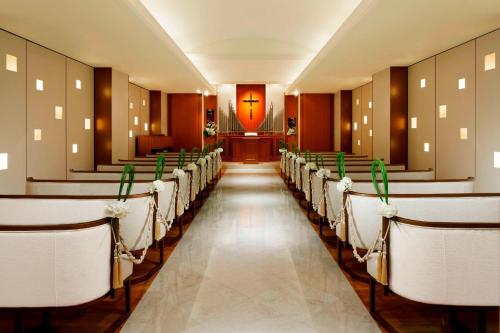 a row of chairs in a room with a aisle at Yokohama Bay Sheraton Hotel and Towers in Yokohama