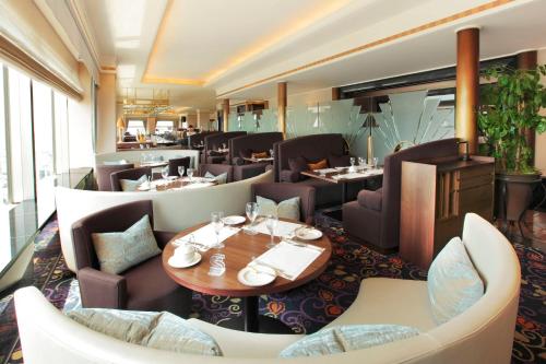 a dining room with tables and chairs and a restaurant at Yokohama Bay Sheraton Hotel and Towers in Yokohama