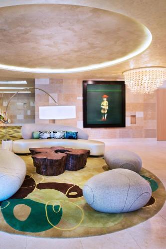 a living room with a couch and a tv at W Singapore - Sentosa Cove in Singapore