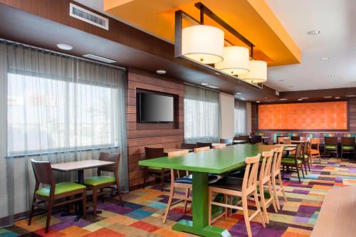 a conference room with a green table and chairs at Fairfield Inn & Suites Waco South in Waco