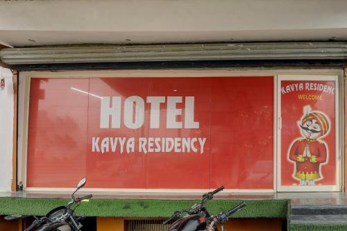 two motorcycles parked in front of a hotel kiryakra residency at Hotel O KAVYA RESIDENCY in Alīgarh