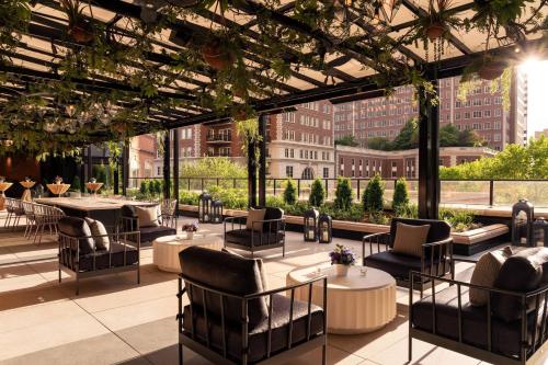 a rendering of a rooftop patio with tables and chairs at The Ritz-Carlton, St. Louis in Clayton