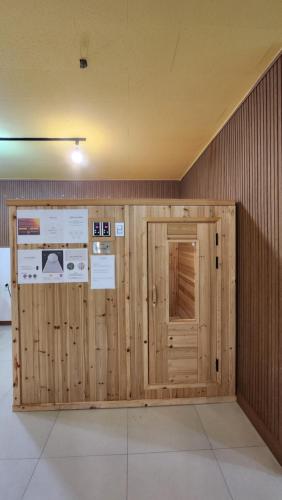 a wooden wall with a door in a room at Elegance hotel hwangridan in Gyeongju