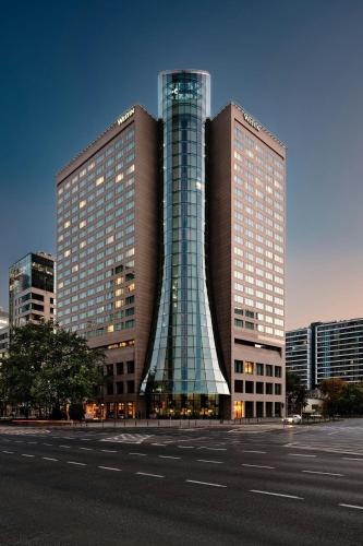 a large building with a glass facade in a city at The Westin Warsaw in Warsaw