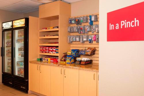 a store with a counter in a pharmacy with a refrigerator at TownePlace Suites Des Moines Urbandale in Johnston
