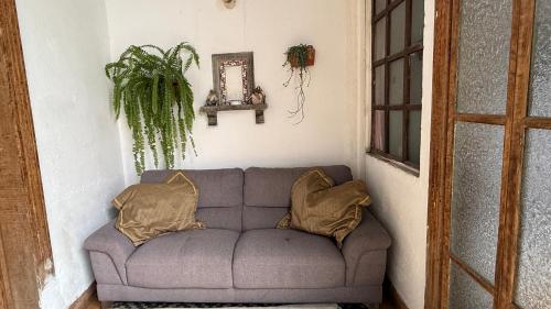 a couch in a room with two pillows on it at CASA DE LAS FLORES in Guatemala
