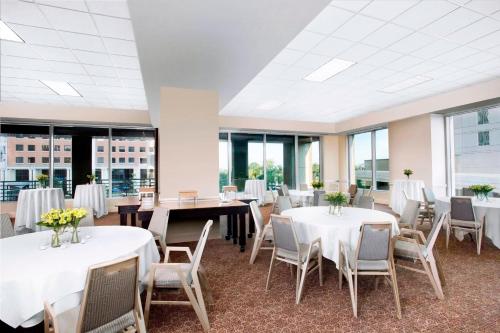 a conference room with tables and chairs and windows at Sheraton Raleigh Hotel in Raleigh