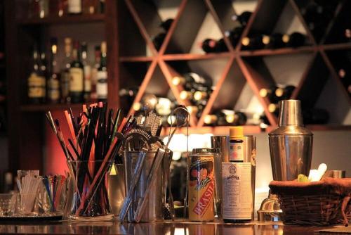 a bar with a counter with several bottles of alcohol at Alexis Hotel in Chania Town