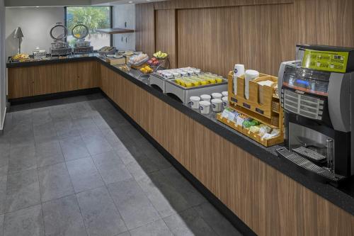 a buffet line in a restaurant with food on it at City Express by Marriott Los Mochis in Los Mochis