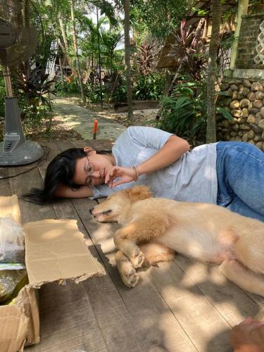 a woman laying on the ground with a dog at mehome in Cư Chinh