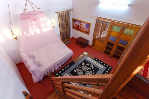 a room with a bed and a wooden door at Sea Hut Homestay in Cochin