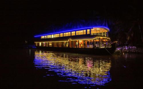 a boat floating on the water at night at Thirumala Cruise in Udupi