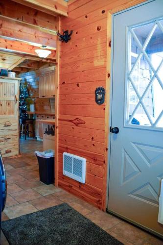 a door in a room with a kitchen and a kitchen at Cozy Bear Cabin Getaway in Island Park