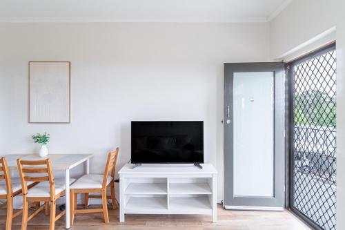 a living room with a table with a television on it at Charming Modern Retreat with Scenic View - Burnside in Burnside